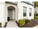 Townhome front entrance with grey door, manicured landscaping, and house number at 482 Captiva Dr, Davenport, FL 33836