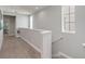 Upstairs hallway with carpet flooring and natural light from the window and access to other rooms at 482 Captiva Dr, Davenport, FL 33836