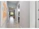 Hallway that leads to the living room, powder bath, and outdoor patio at 482 Captiva Dr, Davenport, FL 33836