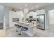 Kitchen with island, granite countertops, stainless appliances and three barstools at 482 Captiva Dr, Davenport, FL 33836