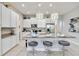 Kitchen with island, granite countertops, stainless appliances and three barstools at 482 Captiva Dr, Davenport, FL 33836