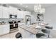 Kitchen with island, granite countertops, stainless appliances and three barstools at 482 Captiva Dr, Davenport, FL 33836