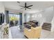 Open concept living room with view to the dining room, stairs, and covered patio with outdoor furniture at 482 Captiva Dr, Davenport, FL 33836