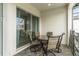 View of the covered patio with a glass table, four chairs and access to indoor seating at 482 Captiva Dr, Davenport, FL 33836