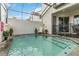View of the pool with fountain jets, stone deck and screened enclosure at 482 Captiva Dr, Davenport, FL 33836