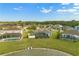 A sprawling green lawn leads to a tranquil lake, perfect for relaxing and enjoying nature at 5335 Coral Vine Ln, Kissimmee, FL 34758