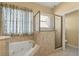 Bathroom with soaking tub and glass-enclosed shower at 5335 Coral Vine Ln, Kissimmee, FL 34758