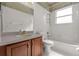 Cozy bathroom featuring a vanity with a wooden cabinet, toilet and a shower over bath at 5335 Coral Vine Ln, Kissimmee, FL 34758