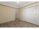 Bedroom featuring a ceiling fan, laminate flooring, and a closet with sliding doors at 5335 Coral Vine Ln, Kissimmee, FL 34758