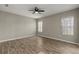 Neutral bedroom with ceiling fan and windows offering picturesque views of the outdoors at 5335 Coral Vine Ln, Kissimmee, FL 34758
