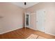 Bedroom featuring wood floors and a doorway leading to other parts of the home at 5335 Coral Vine Ln, Kissimmee, FL 34758