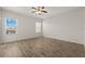Bright bedroom with ceiling fan and two windows showing exterior landscape views at 5335 Coral Vine Ln, Kissimmee, FL 34758