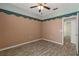Bedroom features wood floors, a ceiling fan and a doorway leading to other parts of the home at 5335 Coral Vine Ln, Kissimmee, FL 34758