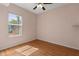 Bedroom with wood floors and a window overlooking the yard, allowing for ample natural light at 5335 Coral Vine Ln, Kissimmee, FL 34758