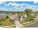 Charming single-story home boasts lake views, lush landscaping, and an attached two car garage at 5335 Coral Vine Ln, Kissimmee, FL 34758