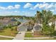 Beautiful single-story home with lush landscaping, mature palm trees, and an attached two car garage at 5335 Coral Vine Ln, Kissimmee, FL 34758