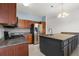 Well-equipped kitchen features stainless steel appliances, granite countertops, and custom cabinetry at 5335 Coral Vine Ln, Kissimmee, FL 34758