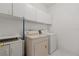 Bright laundry room with ample storage space and modern washer and dryer units at 5335 Coral Vine Ln, Kissimmee, FL 34758