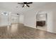Spacious living room with wood floors, archways, and views into the kitchen and entryway at 5335 Coral Vine Ln, Kissimmee, FL 34758