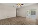 Open-concept living room with ceiling fan and access to a screened lanai, seamlessly connecting indoor and outdoor living at 5335 Coral Vine Ln, Kissimmee, FL 34758