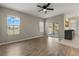Spacious living room featuring a ceiling fan and sliding glass doors leading to a lanai and pool at 5335 Coral Vine Ln, Kissimmee, FL 34758