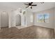 Inviting living space with a decorative chandelier and large windows, complemented by wood floors at 5335 Coral Vine Ln, Kissimmee, FL 34758