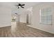 Open floor plan featuring wood flooring and views of the pool from the living space at 5335 Coral Vine Ln, Kissimmee, FL 34758