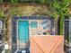 Aerial view of a private pool and spa with a screened in enclosure at 5412 Solterra Cir, Davenport, FL 33837