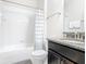 Bathroom featuring a shower and tub combination, granite counter tops, and a dark wood vanity at 5412 Solterra Cir, Davenport, FL 33837