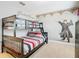 Themed bedroom featuring unique wall art and a bunk bed at 5412 Solterra Cir, Davenport, FL 33837