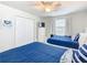 Bedroom featuring two beds with blue linens, a dresser with a TV, and a closet at 5412 Solterra Cir, Davenport, FL 33837