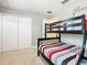 bedroom featuring a bunk bed, neutral walls, and closet at 5412 Solterra Cir, Davenport, FL 33837