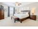 Bedroom with a bed, a dark wood furniture set, carpet, and neutral colored walls at 5412 Solterra Cir, Davenport, FL 33837