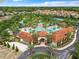 Aerial view of a community pool and recreation area surrounded by trees at 5412 Solterra Cir, Davenport, FL 33837