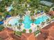 Aerial view of a large community pool featuring waterslides and a lazy river at 5412 Solterra Cir, Davenport, FL 33837