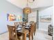 The dining room offers natural light, a stylish chandelier, and a beautifully set table, perfect for Gathering meals at 5412 Solterra Cir, Davenport, FL 33837