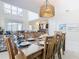 The dining room offers natural light, a stylish chandelier, and a beautifully set table, perfect for Gathering meals at 5412 Solterra Cir, Davenport, FL 33837