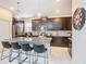 Modern kitchen with stainless steel appliances, dark cabinets, and a large island at 5412 Solterra Cir, Davenport, FL 33837