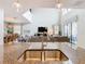 View from kitchen island into the living room with large windows and comfortable seating at 5412 Solterra Cir, Davenport, FL 33837