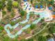 Aerial view of a lazy river and pool featuring inner tubes and trees at 5412 Solterra Cir, Davenport, FL 33837