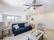 Living room featuring a blue couch, patterned chair, gray walls, and neutral décor at 5412 Solterra Cir, Davenport, FL 33837