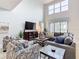 Bright living room featuring tall ceilings, neutral colors, and comfortable seating at 5412 Solterra Cir, Davenport, FL 33837