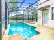 A beautiful private screened in pool with a spa and door leading to the outside at 5412 Solterra Cir, Davenport, FL 33837