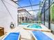 Private screened in pool with spa and lounge chairs to enjoy relaxing outside at 5412 Solterra Cir, Davenport, FL 33837