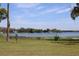 Picturesque view of a serene lake framed by lush greenery at 5870 Cypress Shores Ct, Orlando, FL 32839