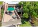 Aerial view of a spacious condo patio featuring an outdoor dining set, grill, and green tree at 601 W Old Us Highway 441 # 9B, Mount Dora, FL 32757