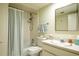 Cozy bathroom featuring a shower-tub combo and vanity with neutral decor at 601 W Old Us Highway 441 # 9B, Mount Dora, FL 32757