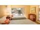Relaxing bedroom with two twin beds, large windows, and an outdoor view at 601 W Old Us Highway 441 # 9B, Mount Dora, FL 32757