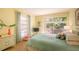 Comfortable bedroom with a king-size bed and a door to an outdoor patio at 601 W Old Us Highway 441 # 9B, Mount Dora, FL 32757