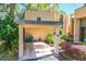 Attached carport entrance for unit 9B, with lush landscaping and garden area and driveway at 601 W Old Us Highway 441 # 9B, Mount Dora, FL 32757